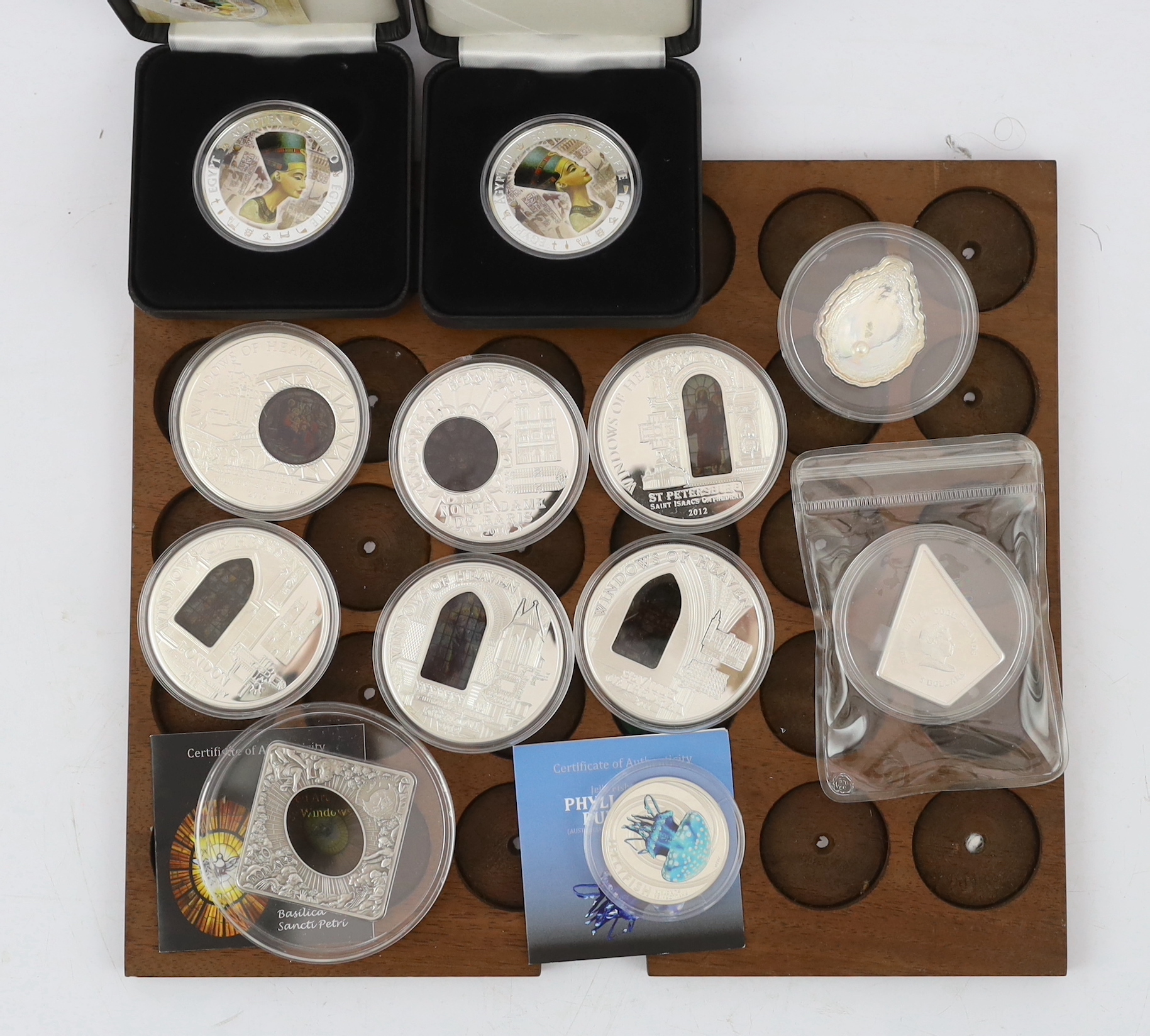 Elizabeth II Cook Islands silver proof commemorative coins, six windows of heaven $10, a Christmas 2009 $5, Republic of Palau shells of the sea 2011 $5 ‘pearl oyster’, Sacred Art Holy Windows 2011 $10, two Fiji Nefertiti